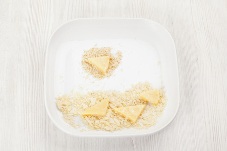 cheese coated in sesame seeds and almond in a bowl closeupの写真素材