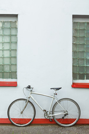 Retro bike near gray wall outdoors. Trendy hipster bike outdoorsの写真素材
