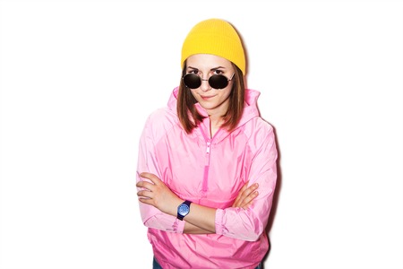 Lovely girl in yellow hat and sunglasses isolated on white background. Portrait of a girl hipsterの写真素材