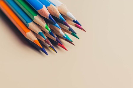 Multicolored pencils on a beige background. Copy space. Back to school conceptの写真素材