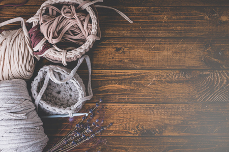 Knitting. Home hobby. Wabi-Sabi-style composition on a wooden background. Top view. Easy vintage toningの写真素材