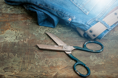 Old jeans and tailors on a rustic background. Toning in the style of Denim.の写真素材
