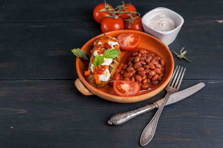 Baked potatoes with mozzarella cheese and vegetables, with stewed beans in tomato sauce. Vegetarian foodの写真素材