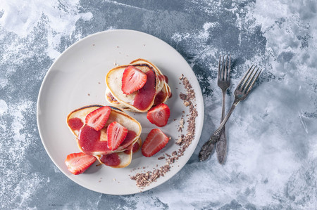Pancakes with strawberry jam and fresh strawberry slices. Top viewの写真素材
