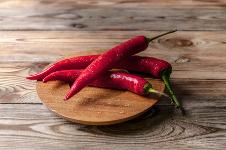 Red hot chili pepper on a wooden backgroundの写真素材