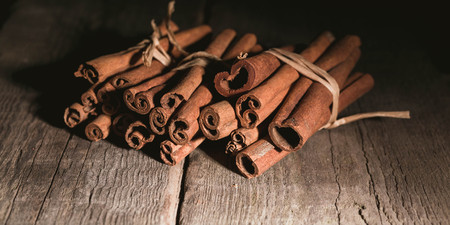 Cinnamon sticks on a wooden background. Low key lightingの写真素材