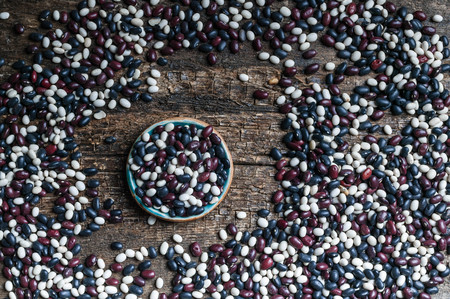 Seeds of colored beans on a wooden background. Top viewの写真素材