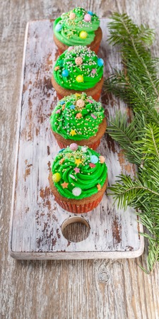 Christmas Muffins with Green Cream on a wooden backgroundの写真素材
