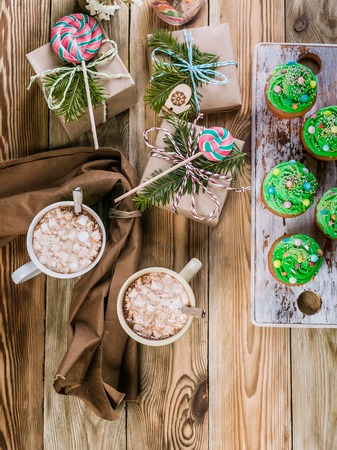 Christmas Muffins with green cream and hot chocolate with marshmallows. Top viewの写真素材