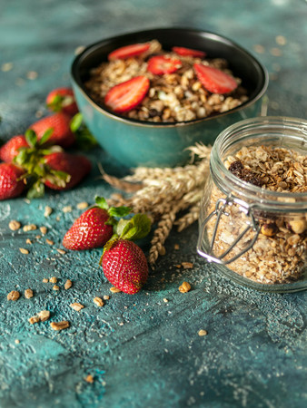 Homemade Granola. Baked muesli and fresh strawberries. Delicious and healthy breakfast. Selective...