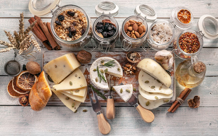 Assorted french cheese herbs and seasonings on wooden background