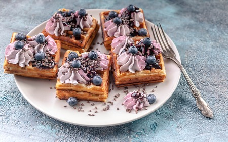 Homemade Belgian waffles with cream, jam, blueberry and mint leaves. Delicious Dessertの写真素材