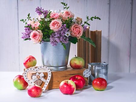 Roses, lilacs, old books and apples. Still lifeの写真素材