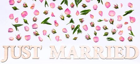 Banner. Floral wedding pattern on a white background. Petals and buds of roses. Blank greeting card or wedding invitation. Word: Just marriedの写真素材