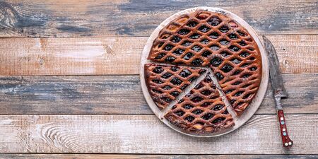 Food banner: homemade open pie with black currant on a rustic background.の写真素材