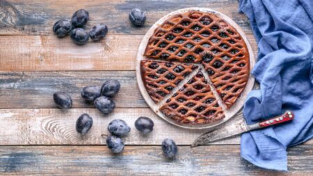 Food banner: Homemade delicious pie with prunes on a rustic background.の写真素材