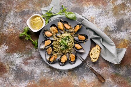 Top view Delicious seafood pasta. Fresh mussels and pesto pasta. Mediterranean Kitchen.の写真素材