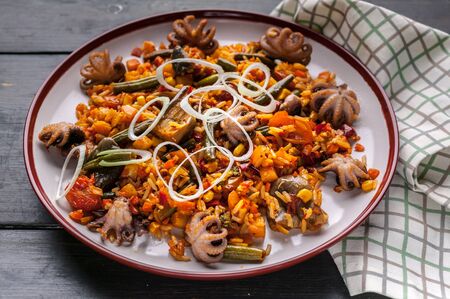 Close-up Traditional spanish paella with octopuses. Mediterranean food. Ketogenic Diet Recipesの写真素材