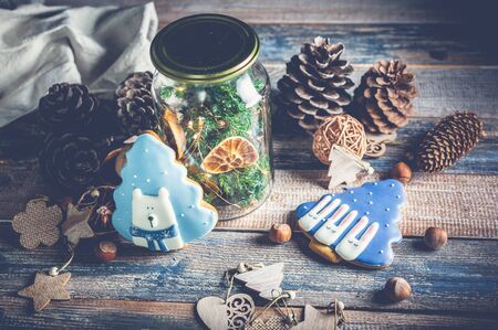 Top view Christmas gingerbread, tree traditional toys on a wooden background. Low key lighting composition.の写真素材