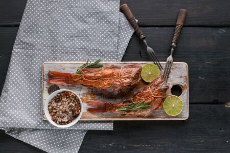Hot smoked fish on a wooden cutting board. Red sea bass fillet. Top view