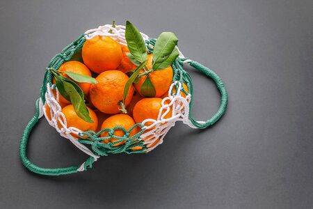 Tangerines in a mesh shopping bag. Zero Waste and NO plastic bag Concept. Copy spaceの写真素材