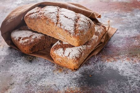Freshly baked sourdough rye flour bread with sunflower and pumpkin seeds on a brown napkin. Copy...
