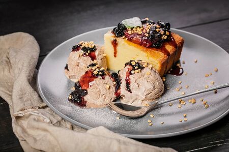 Close-up homemade delicious dessert. Appetizing cupcake with strawberry jam and coffee ice cream on...