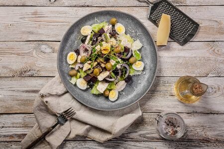 Salad with beets, ice lettuce, sweet onions, sheeps spicy cheese, olives, micro-greens and olive oil. Mediterranean diet. Top view. Copy spaceの写真素材