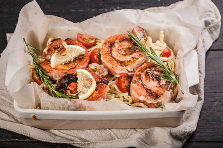 Baked salmon rolls with cream cheese and shrimp meat, sauce ricotta pesto with lemon. Delicious seafood restaurant dishes. Mediterranean Kitchenの写真素材