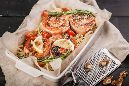 Pasta with pink salmon rolls with walnuts, lemon and rosemary. Delicious seafood restaurant dishes. Mediterranean Kitchenの写真素材