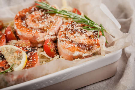 Close-up pasta with pink salmon rolls, walnuts, lemon and rosemary. Delicious seafood restaurant dishes. Mediterranean Kitchenの写真素材
