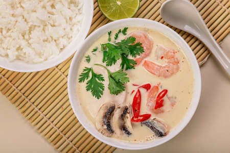 Top view Tom Yam soup. .Traditional asian thai food. Healthy and tasty soup with rice, coconut milk, shrimps and mushrooms.の写真素材