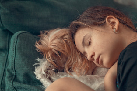 Beautiful girl sleeping with her dog. Best friends. Lifestyleの写真素材