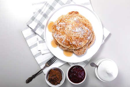 Top view delicious hot pancakes with maple syrup. Traditional delicious dessert or sweet breakfast...