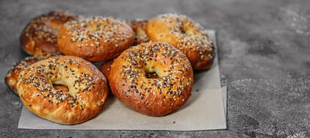 Food banner. Appetizing and crunchy New York bagels with sesame and flax seeds. Homemade hot baked....