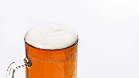 Mug of cold light beer on a white background. Beer foam and bubbles. Traditional light alcoholic drink shot. Close-up. Copy spaceの写真素材