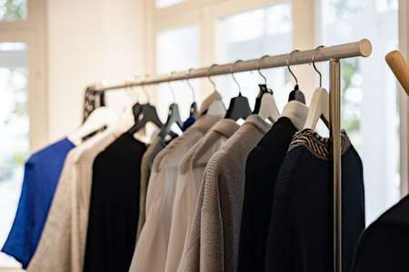 Fashionable stylish women's clothing on a hanger. Branded clothing in a show room. Light background....