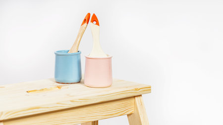 Cans of paint and paintbrush on white background. Do-it-yourself repair and renovation of the house....