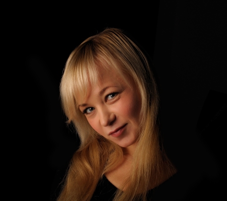young blond hair woman portrait   on dark background.の写真素材