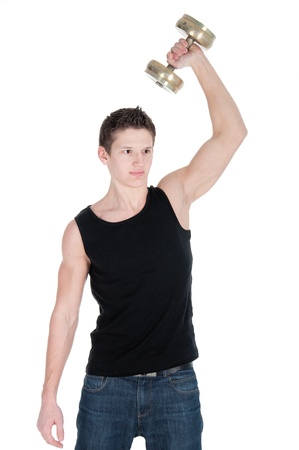 Portrait of a healthy young man doing exercise with dumbbell against white background.の写真素材