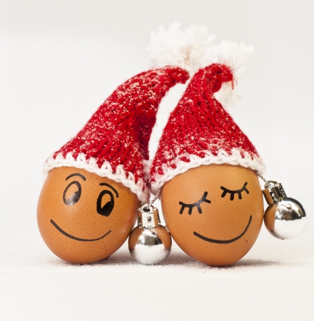 funny lovely  eggs in winter santa hats. sugar like a snowflakes. together is more warmer.の写真素材