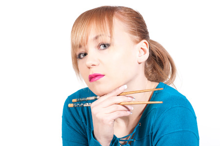 beautiful woman waiting a sushi with chopsticks.の写真素材