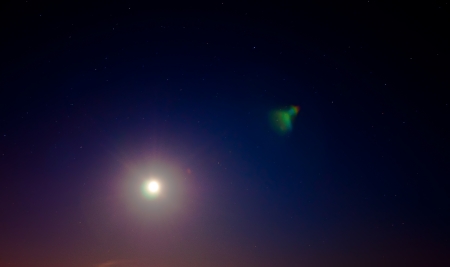 Stars and moon over night sky.の写真素材