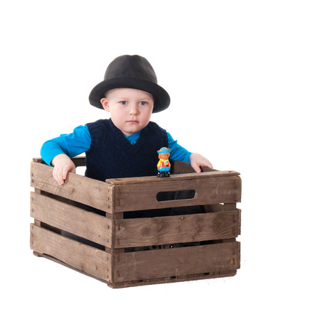 Little boy with hat in wooden box. over white backgroundの写真素材