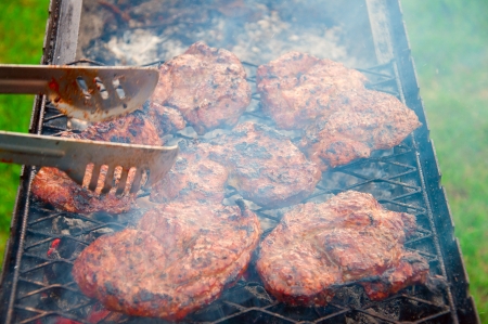 grill meat on charcoal with fork の写真素材