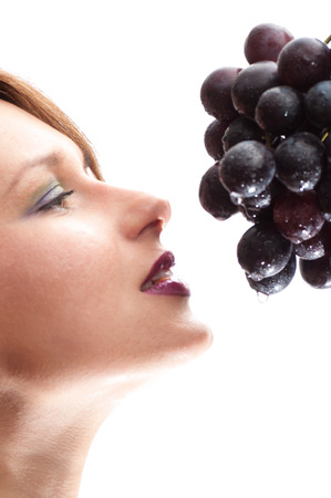 a Beautiful young woman face  with grape.の写真素材