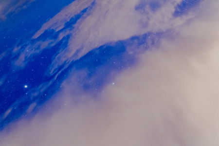 Stars in the night sky with clouds.の写真素材