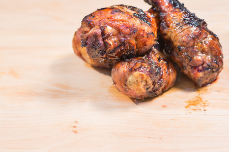 grilled chicken legs on a wooden background の写真素材