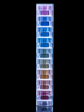 bright and colorful eye shadows stack on dark background