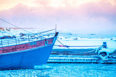 the frozen Baltic sea and fishing boatの写真素材